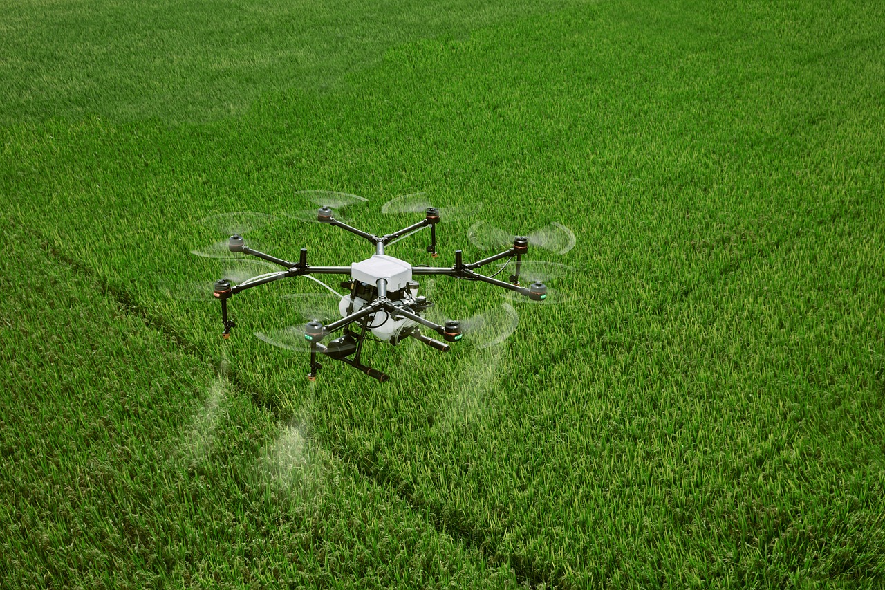 Agriculture drone spraying pesticide over farm fields in Tamil Nadu coordinated by EmptyWagons drone services network.